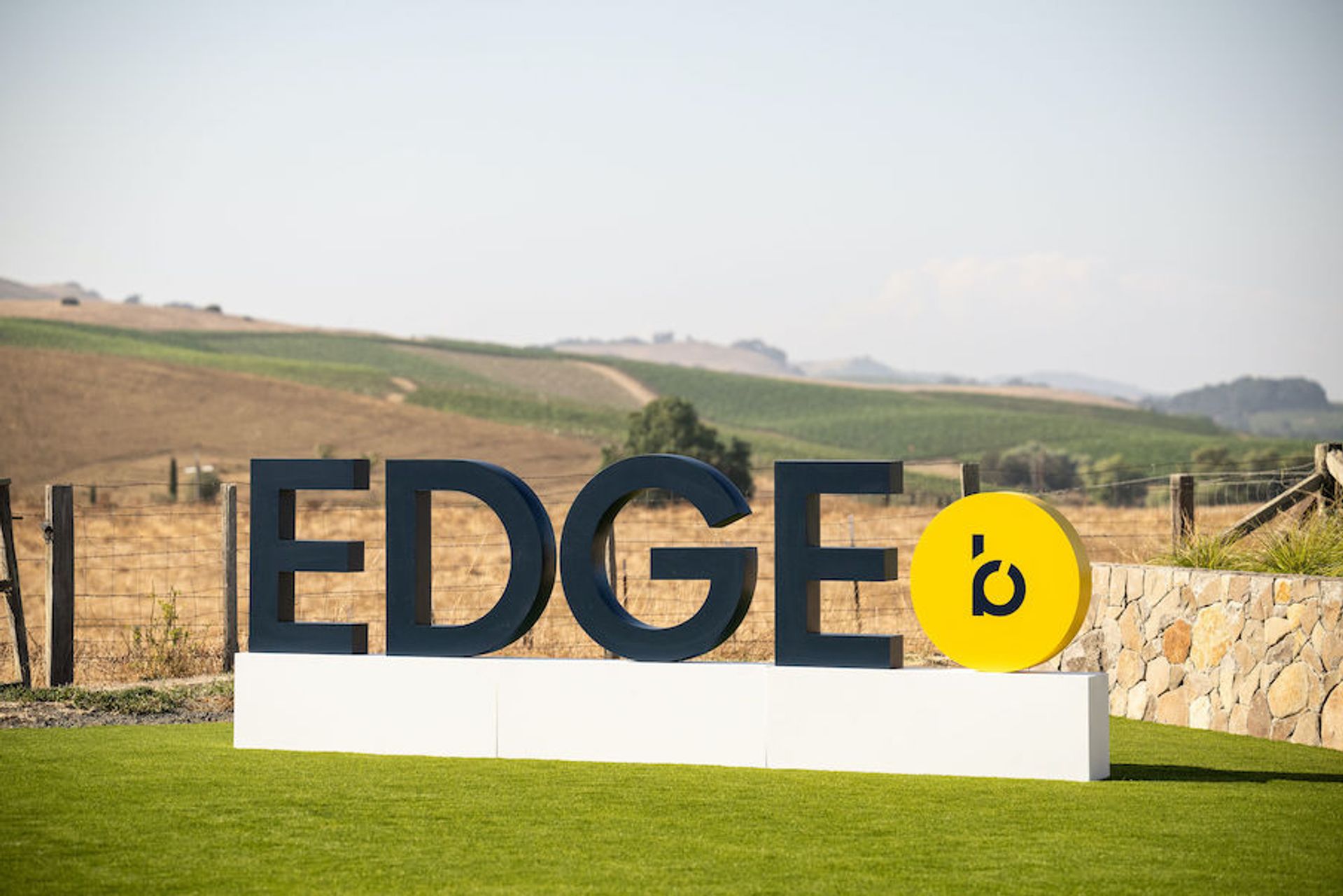 An installation sign of the word "EDGE" with napa valley in the background
