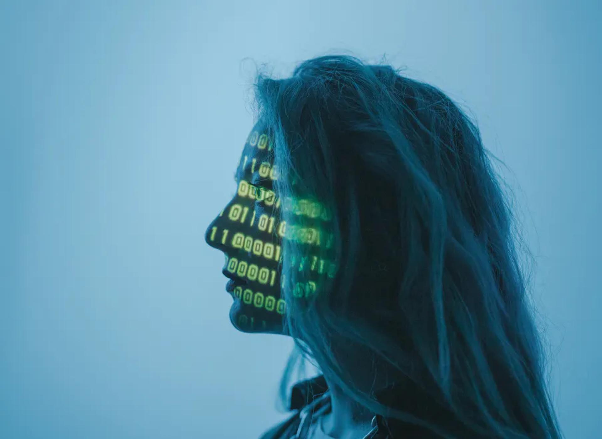 A woman with code light projected on her face