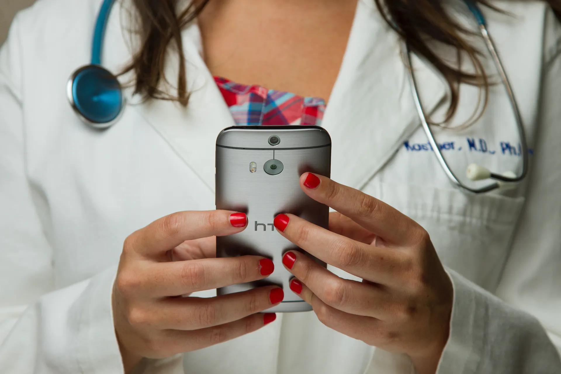 A nurse holding a smartphone