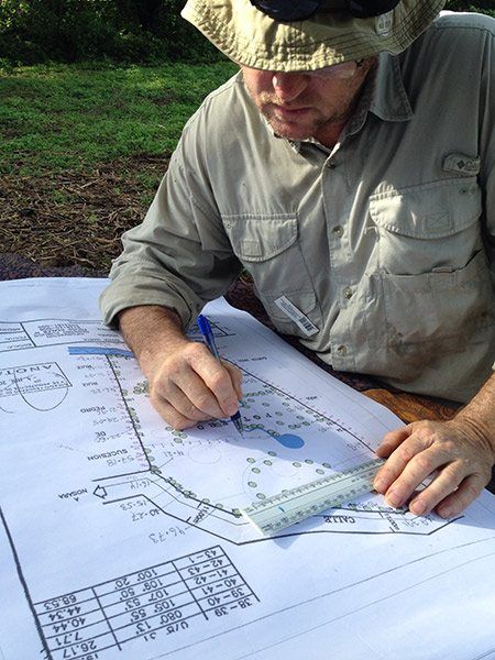 Tim writes in some of the details on a plan of the sanctuary