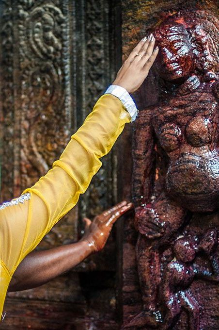 A couple worships at one of the smaller shrines, a fertility shrine, known to help couples conceive a child.