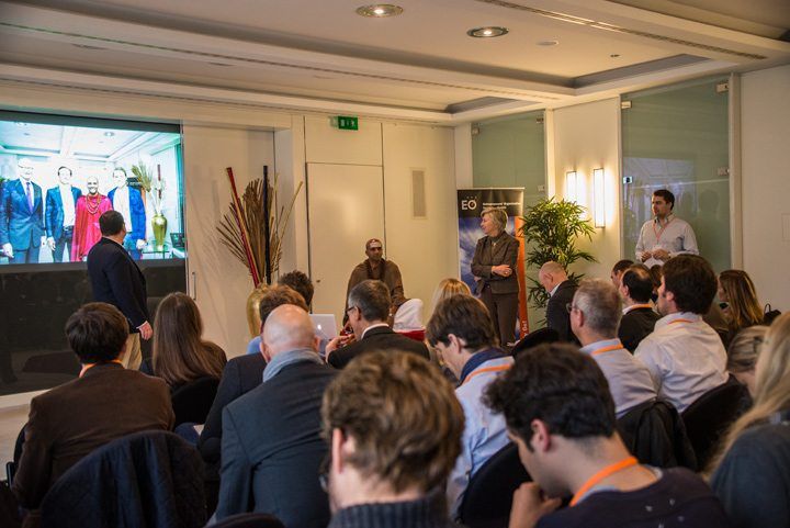 One of the heads of Deustche Bank, who is sponsoring the event, welcomes members and spouses of the Entrepreneurs' Organization.