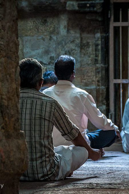 Pilgrims meditating at one of the smaller shrines surrounding the central sanctum.