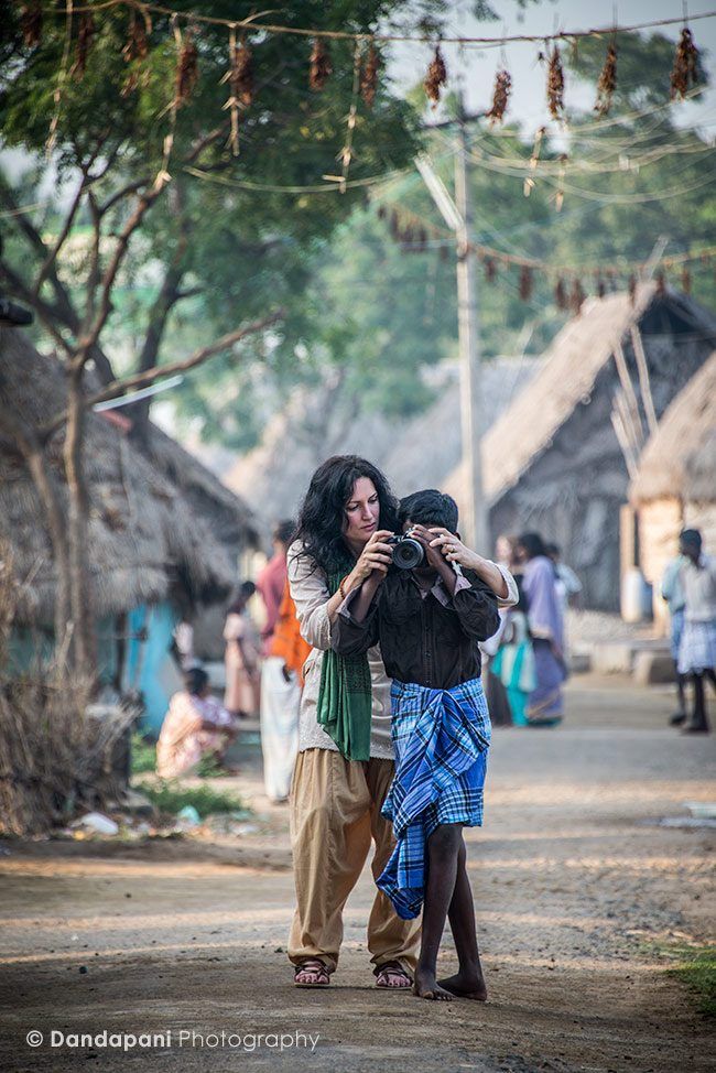One of our participants, Jasmine, teaches a local village boy to use the camera.