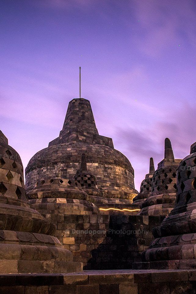 The spectacular Borobudur Temple at pre-dawn lit by a full moon. Gorgeous colors!