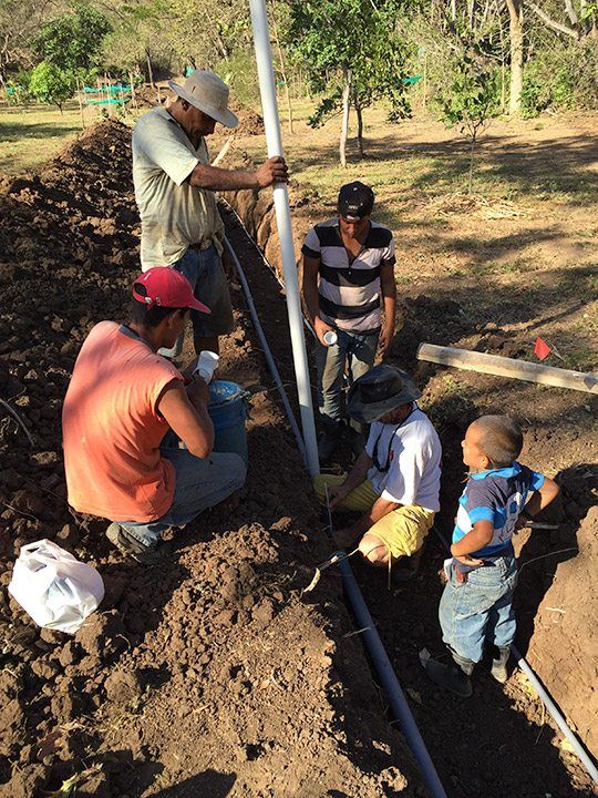 Joe taking charge of laying out 1,000 feet of pipes.
