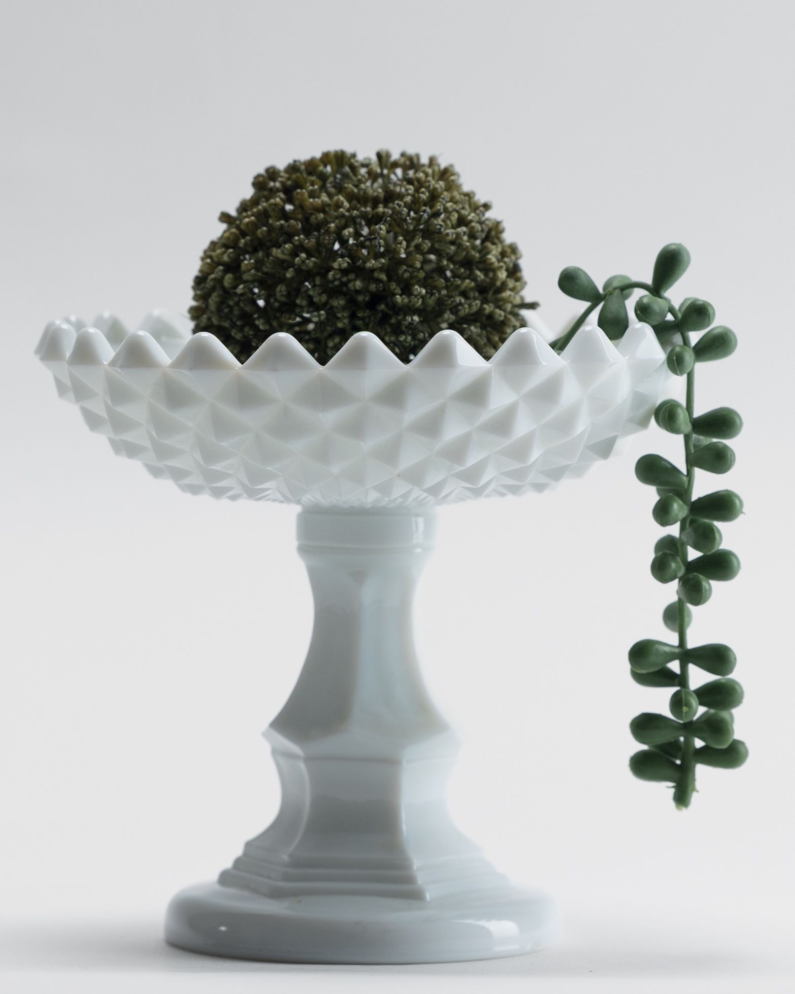 Curated tabletop arrangement with antique silver pieces