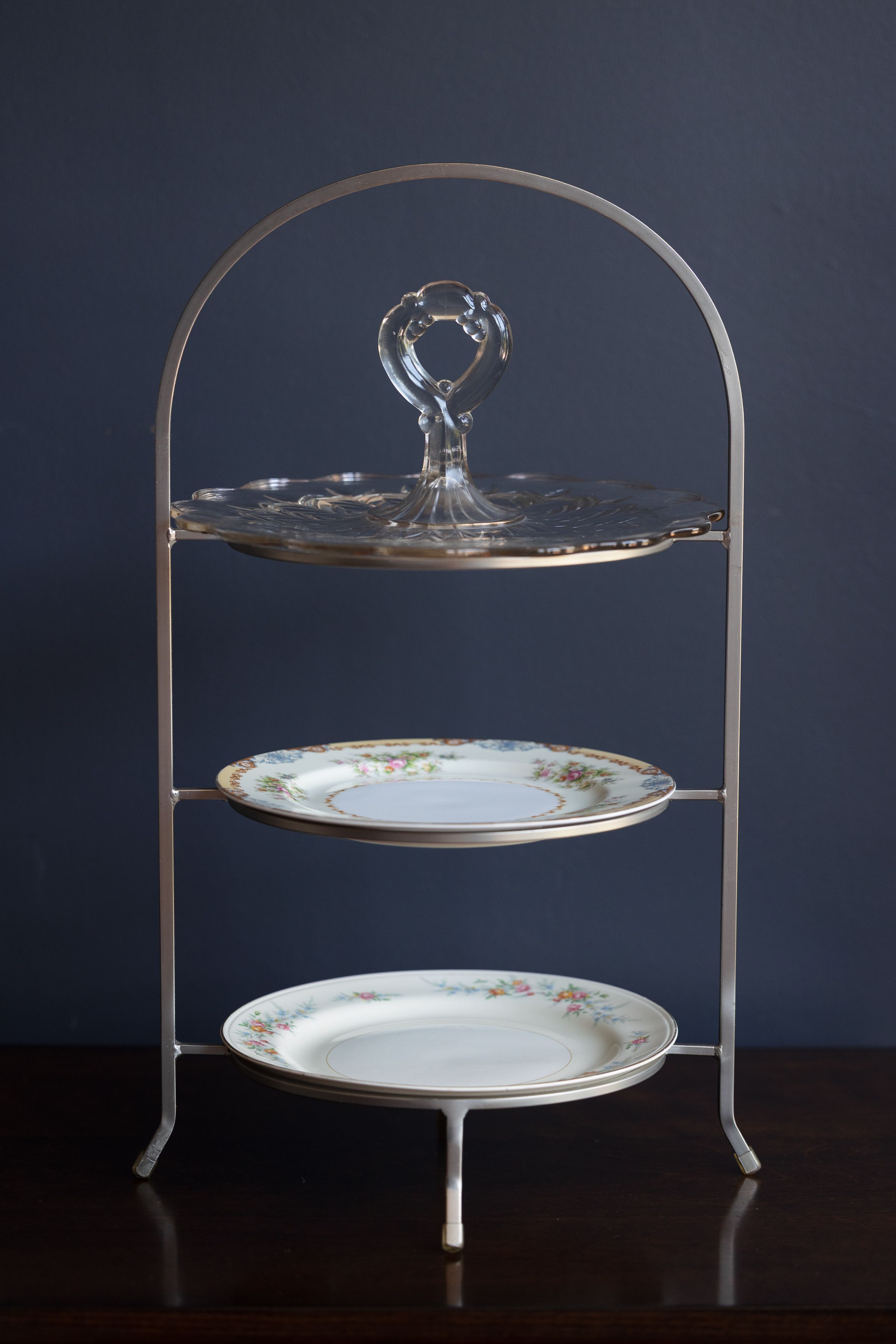 Three-tier serving stand with etched glass and floral china plates