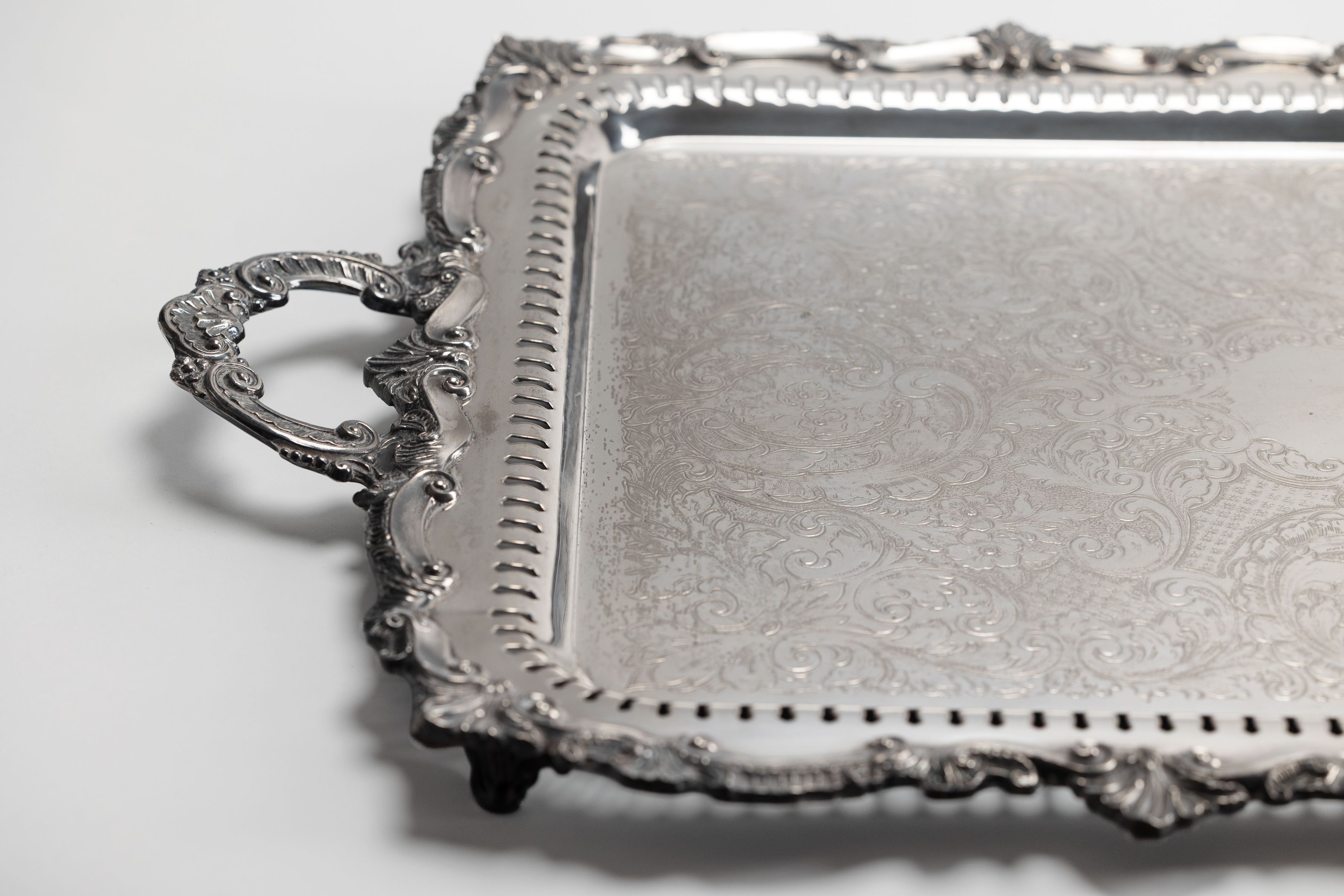 Silver service tray and antique ceramic vessels