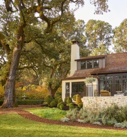 Stone-base cottage set among mature oaks