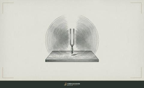 Antique engraving illustration. A tuning fork struck and suspended above a resonating wooden soundboard, vibration lines radiating in perfect symmetry.