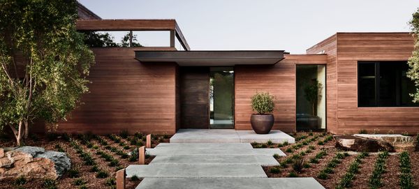 Wood-clad entry with stone walkway