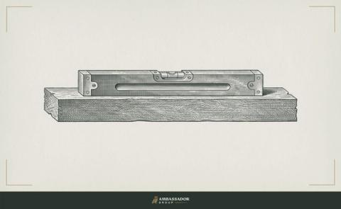 Antique engraving illustration. A carpenter's spirit level rests on a rough-sawn timber beam, its bubble centered in the vial.