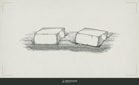 Antique engraving illustration. Two foundation stones of identical size, one seated true and level in the earth, one tilted and already sinking at one corner.