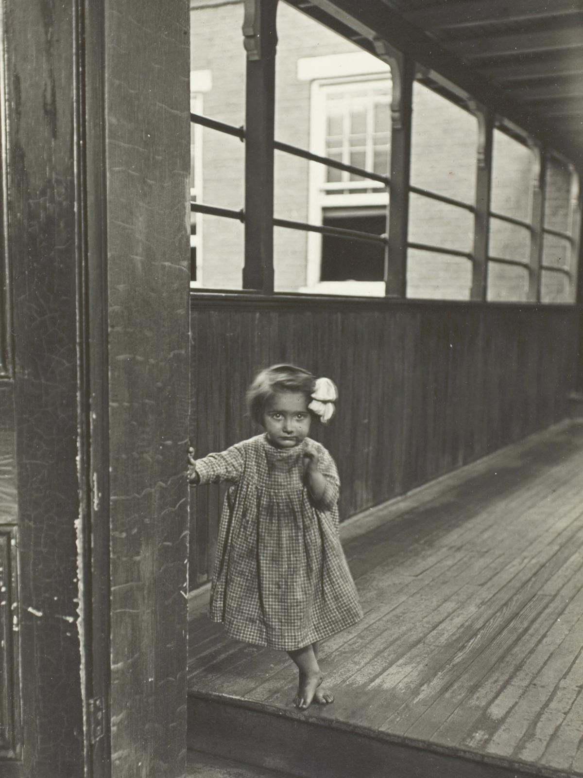 Little Girl Standing at Entrance to a Gallery by Lewis Wickes Hine