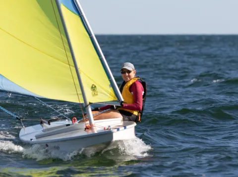 Jane sailing a sunfish on open water.
