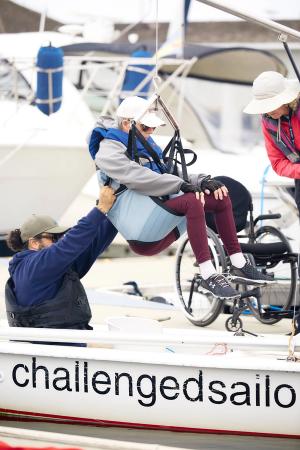 Lifting a sailor into one of the Martin sailboats