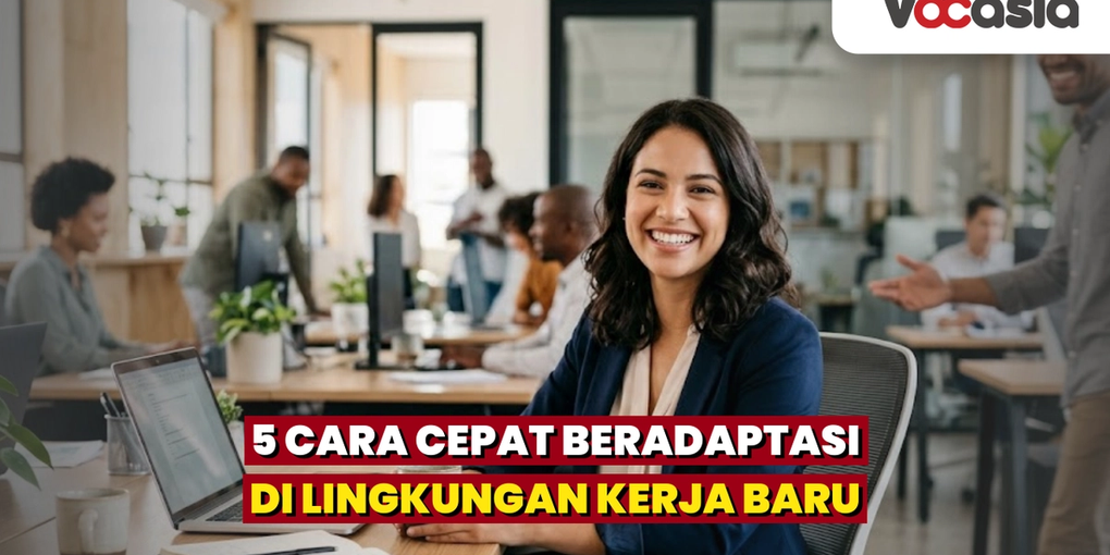 Seorang karyawan baru tersenyum percaya diri di meja kerjanya saat menyapa rekan kerja di lingkungan kantor yang modern.