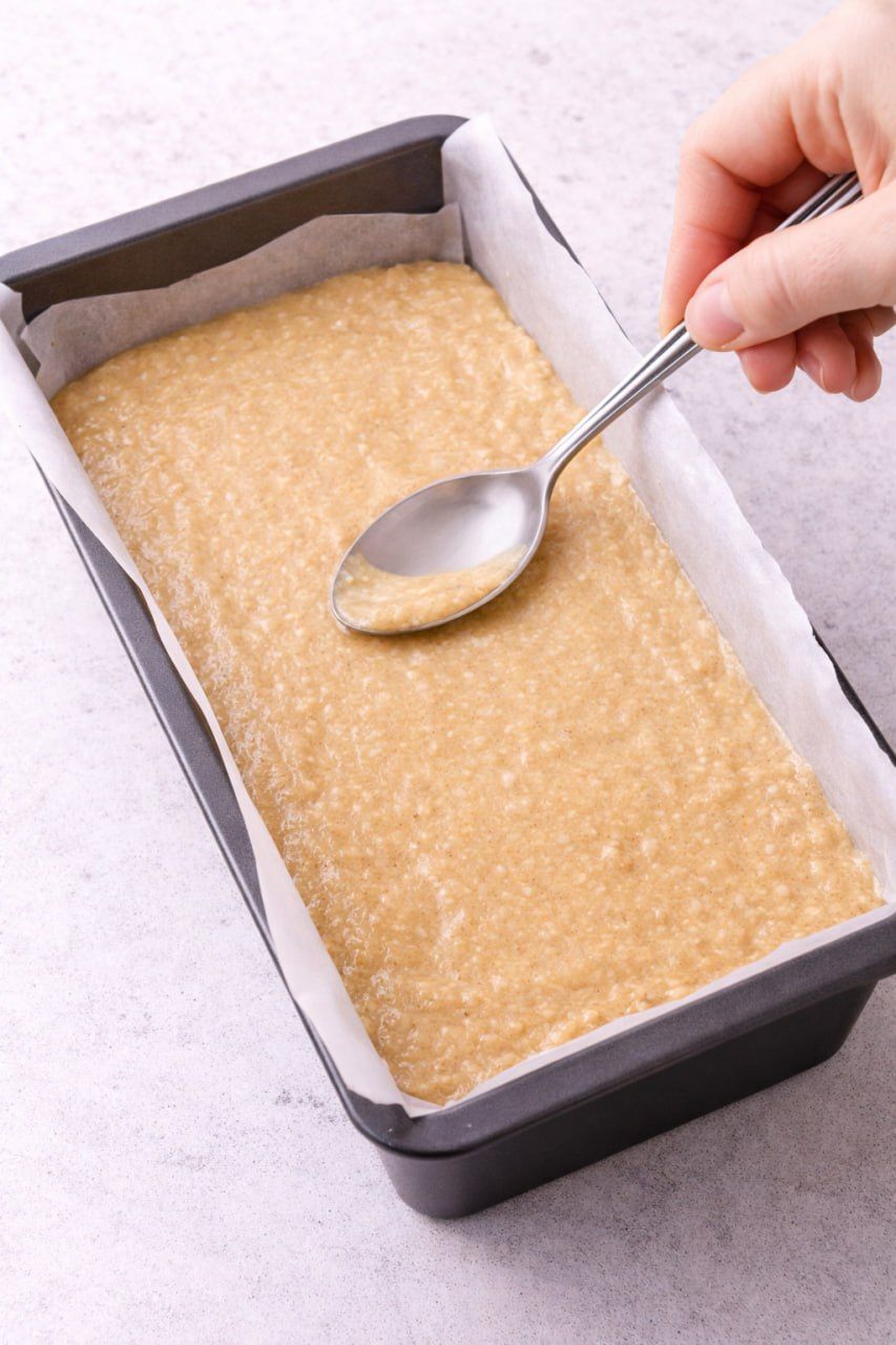 Banana bread batter smoothed into a loaf pan ready for the oven.