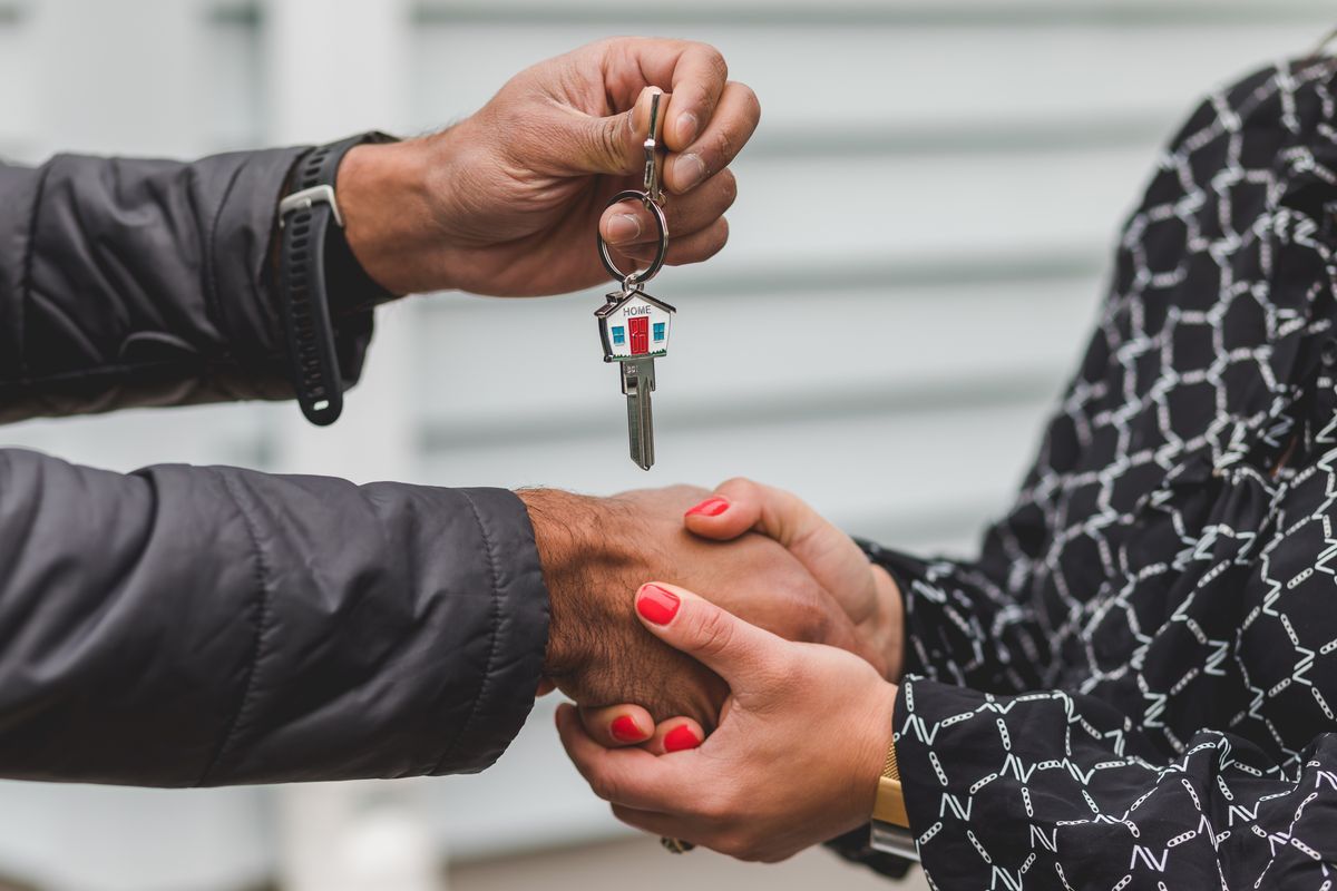 Estate agent reviewing documents with a client