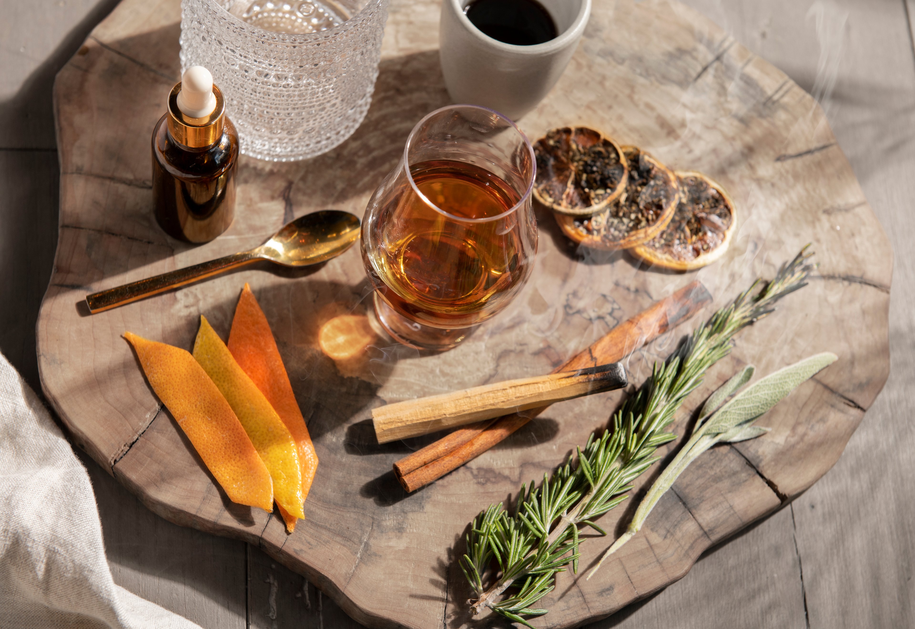 drink and aromatics on a wooden slab