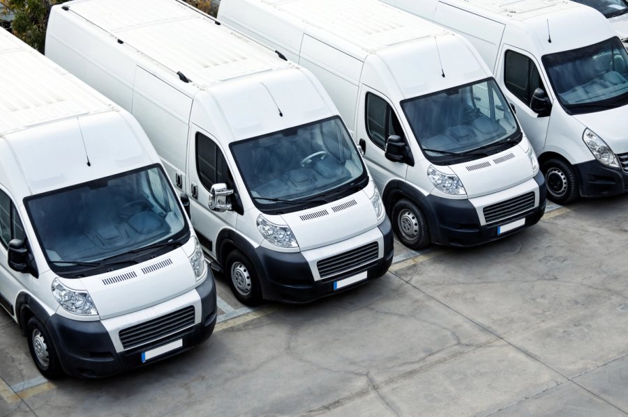 Fleet of delivery vans at warehouse depot