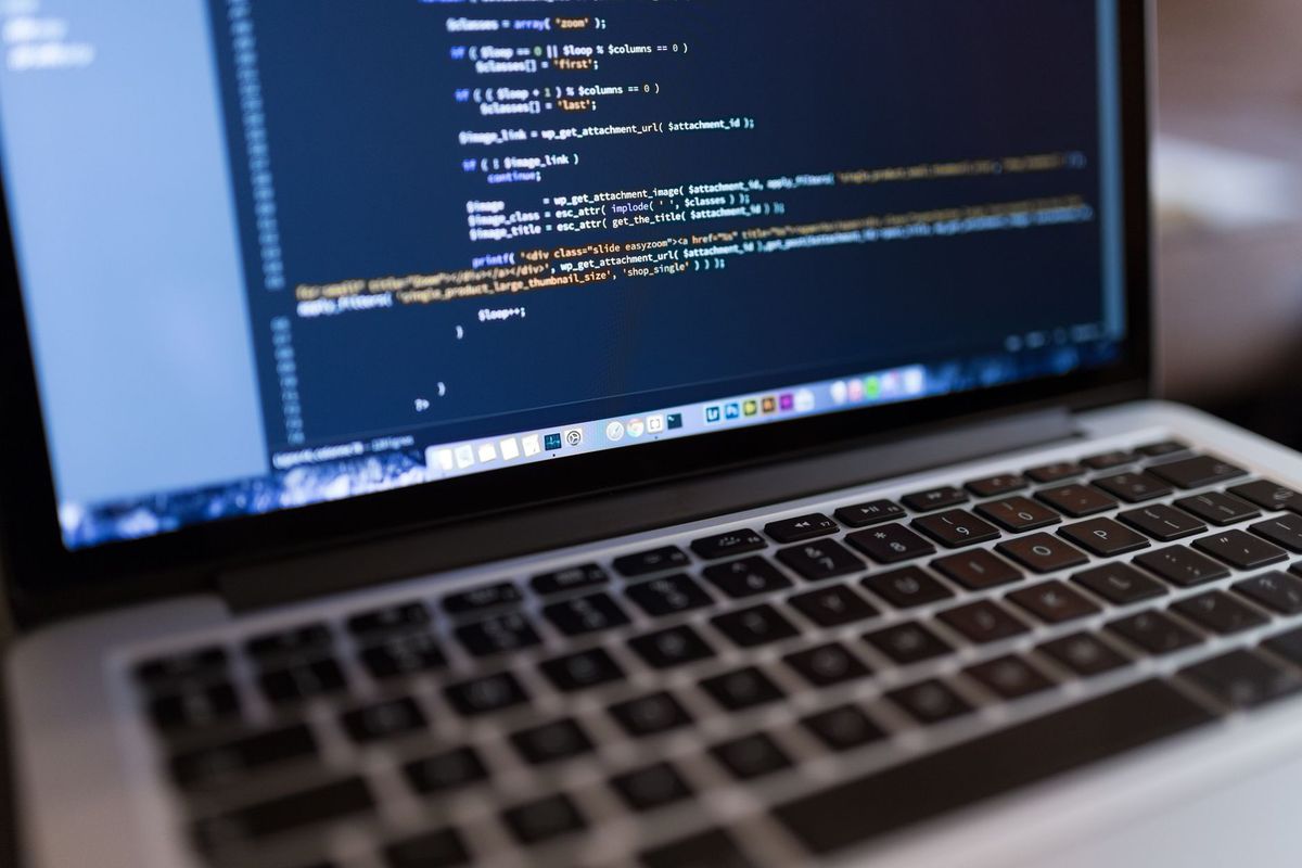 Business owner comparing Astro and WordPress website workflows on a laptop