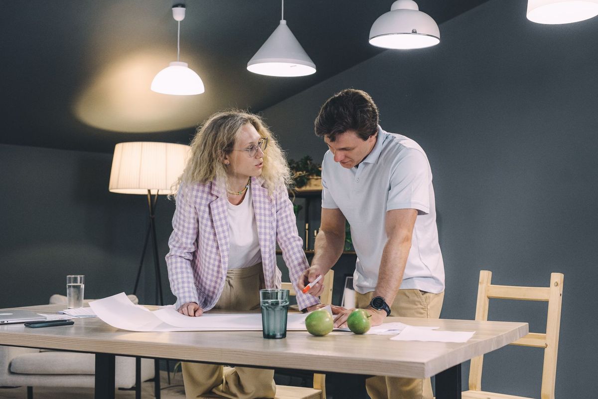 Small business owner and freelance developer checking website maintenance notes after a project launch