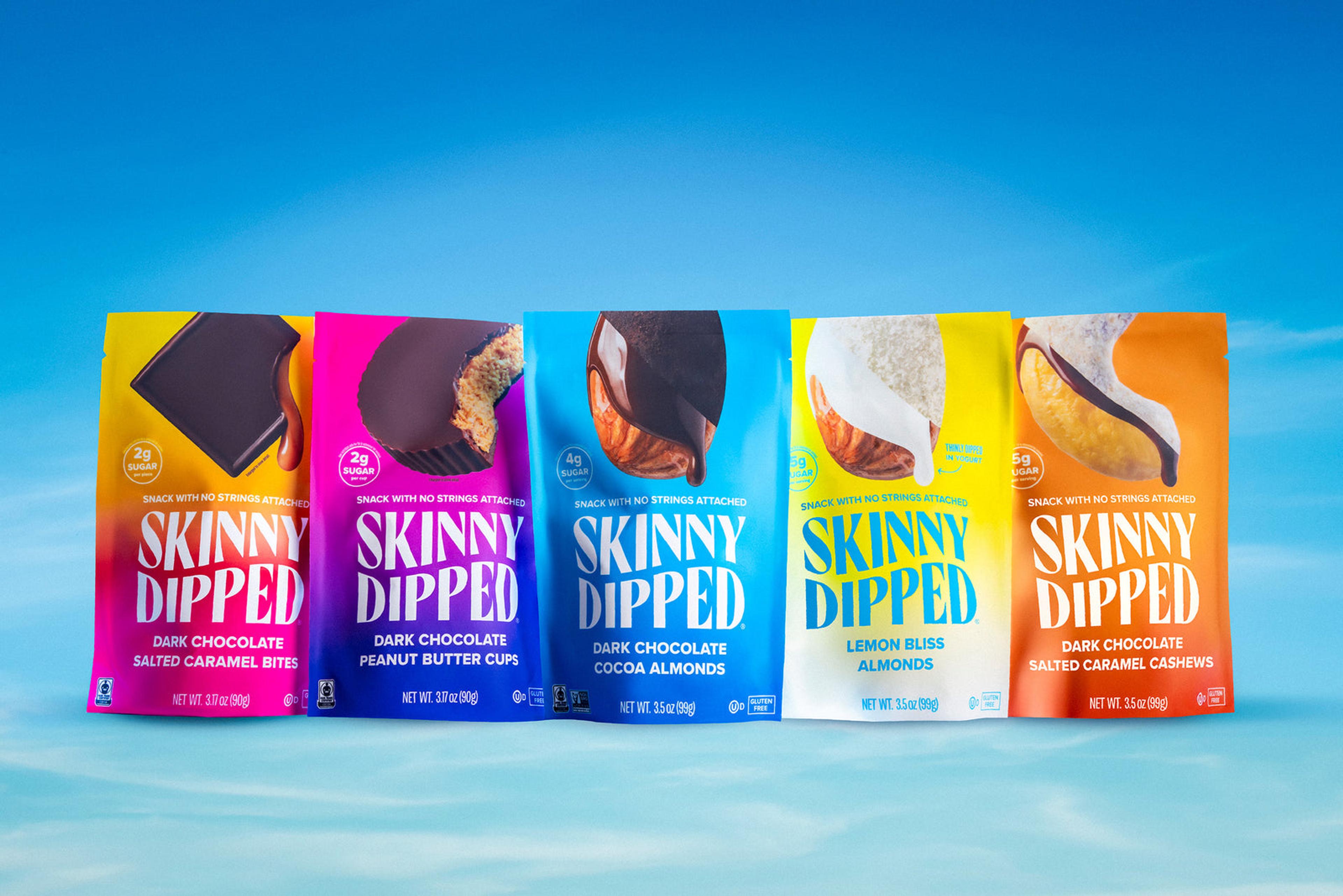 Five SkinnyDipped snack packs against a blue sky