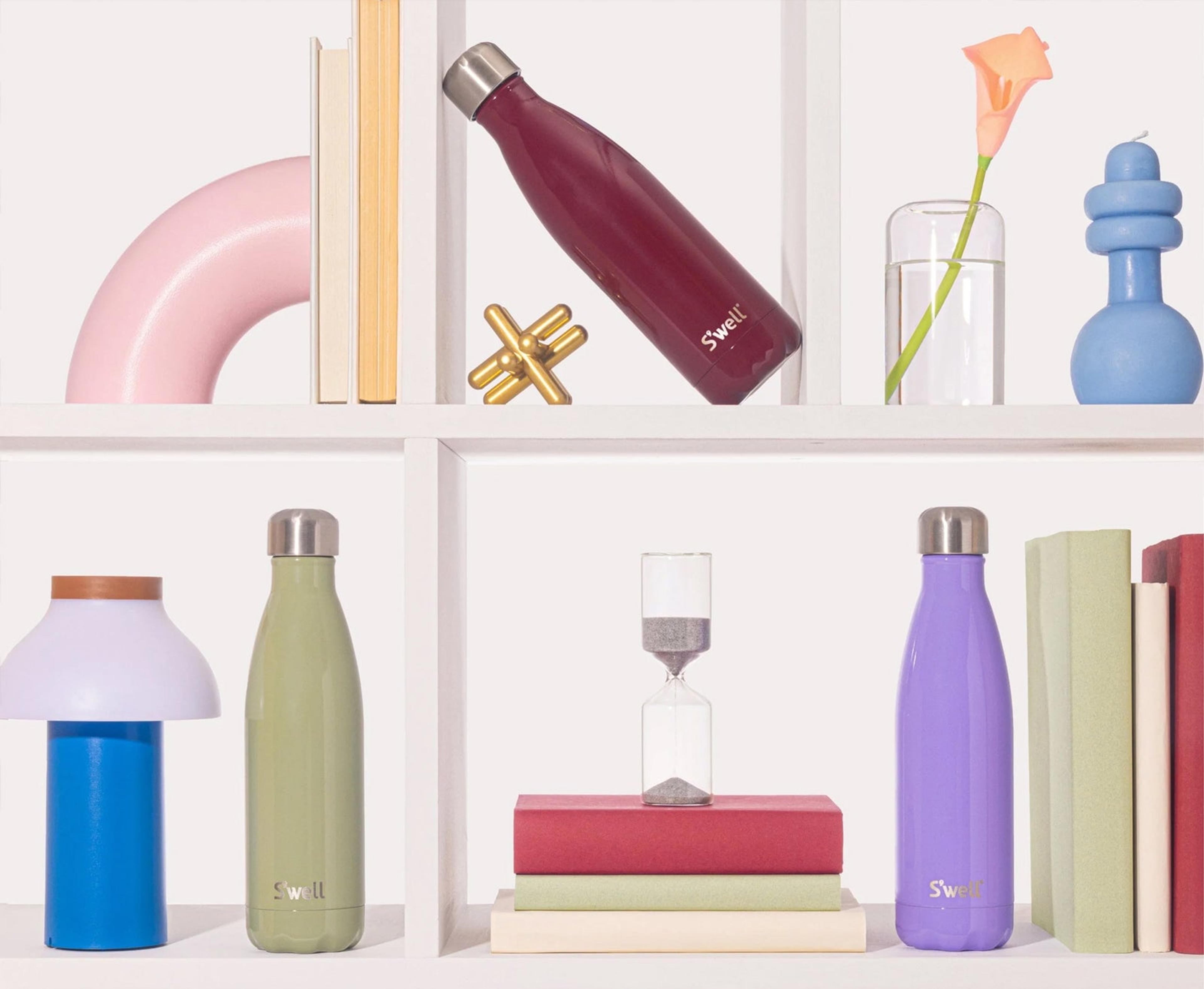 S'well bottles styled on a white shelf