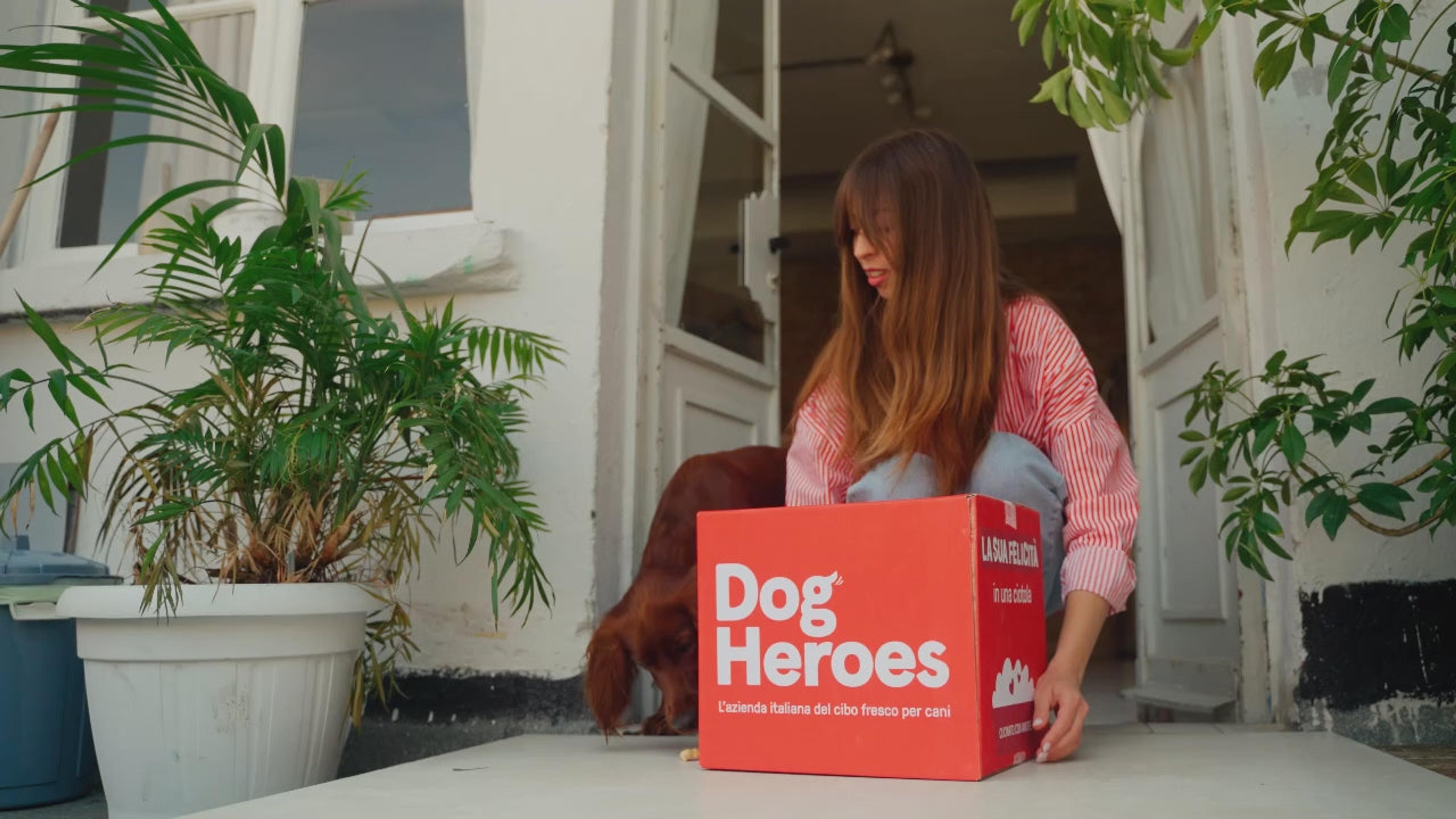 A Dog Heroes delivery box being opened on a doorstep