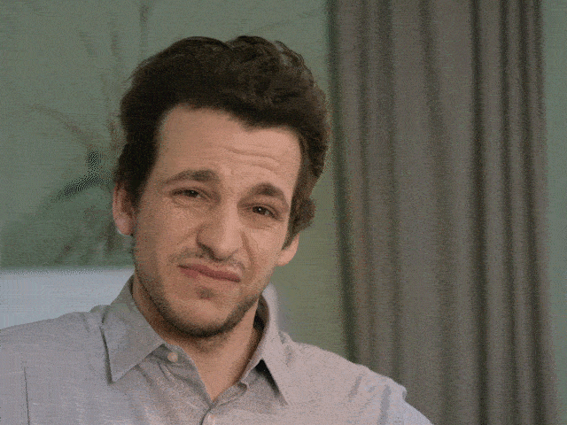 Man pointing thumb down