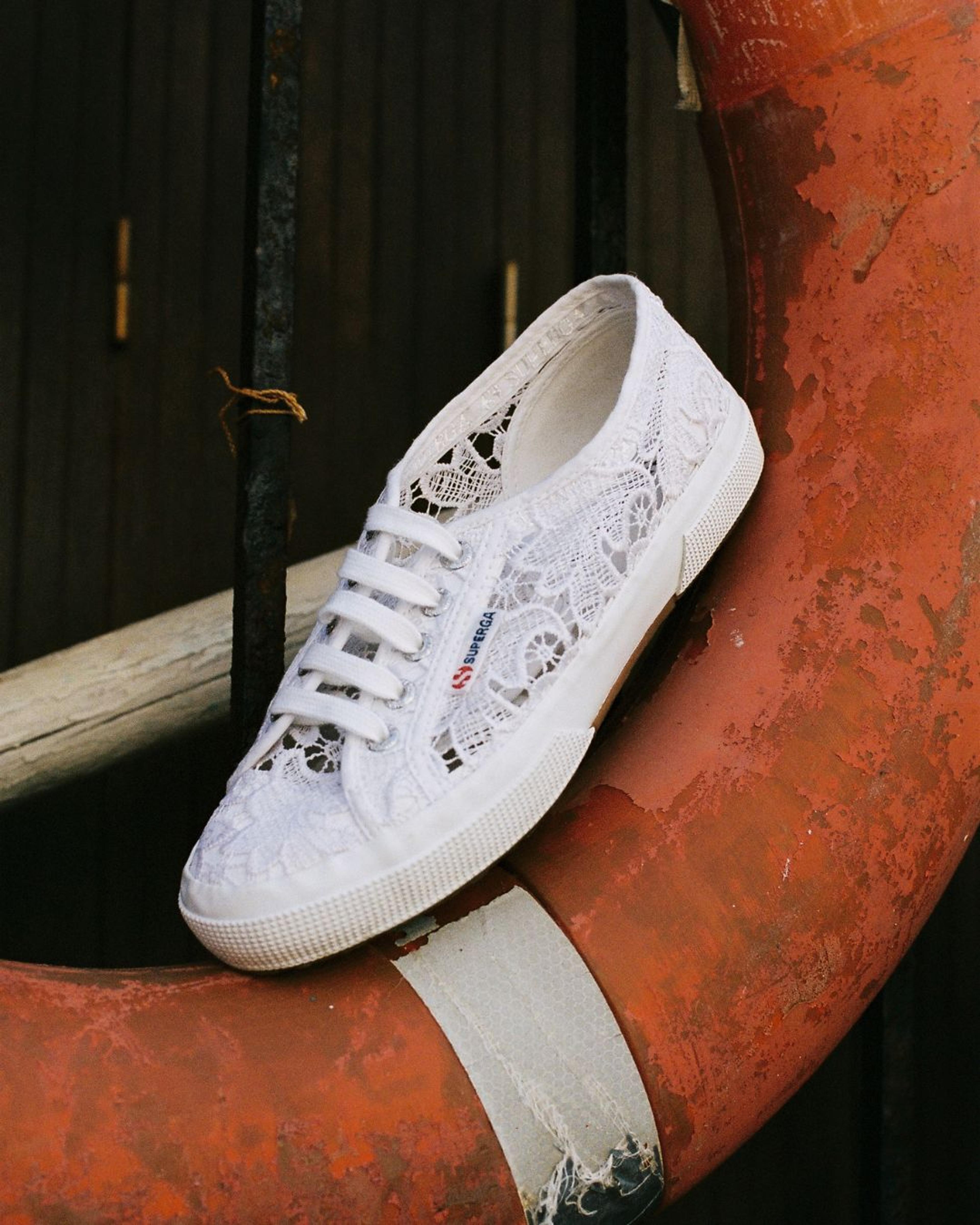 White Superga canvas sneaker resting on a life ring