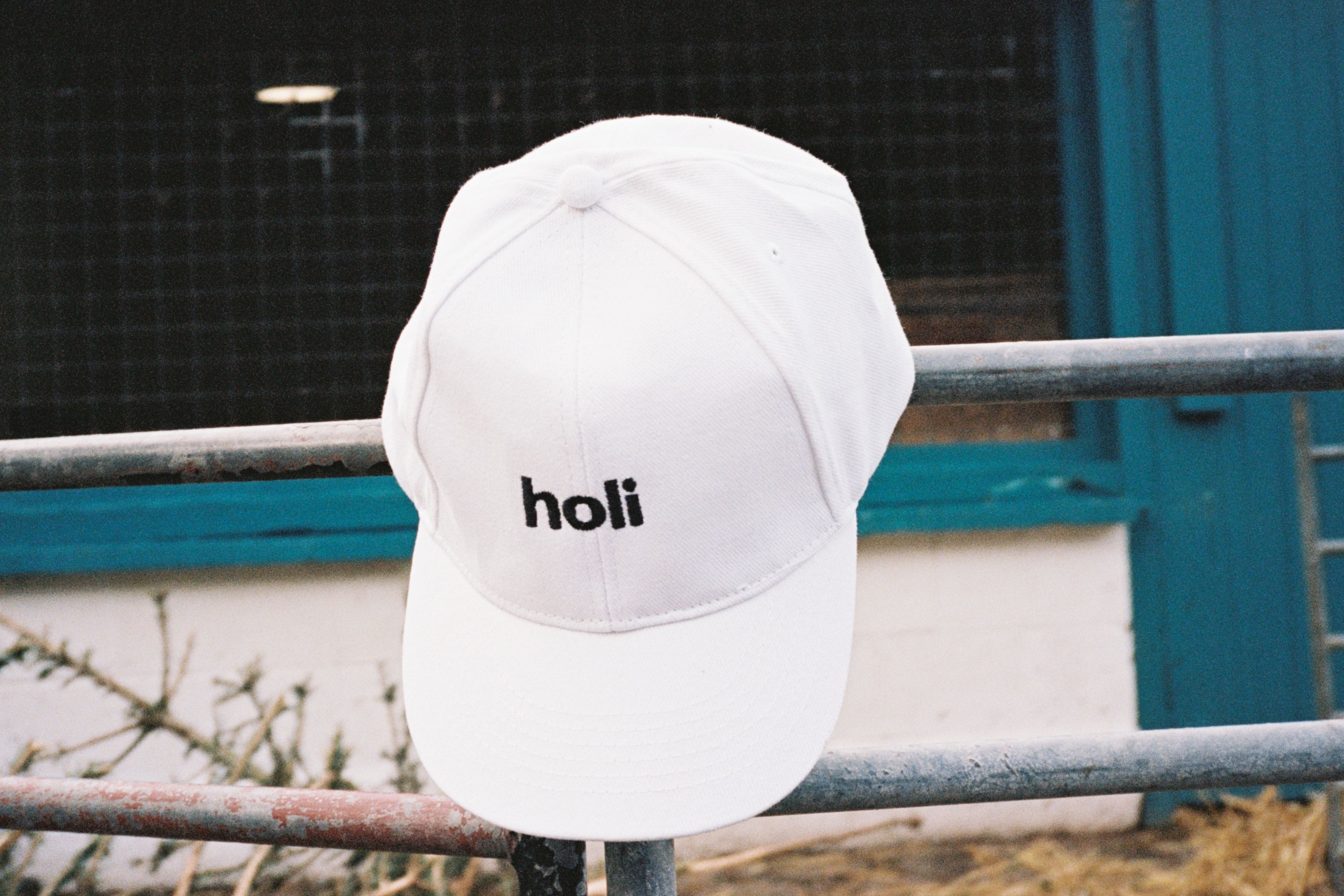 A holi cap sitting on a fence