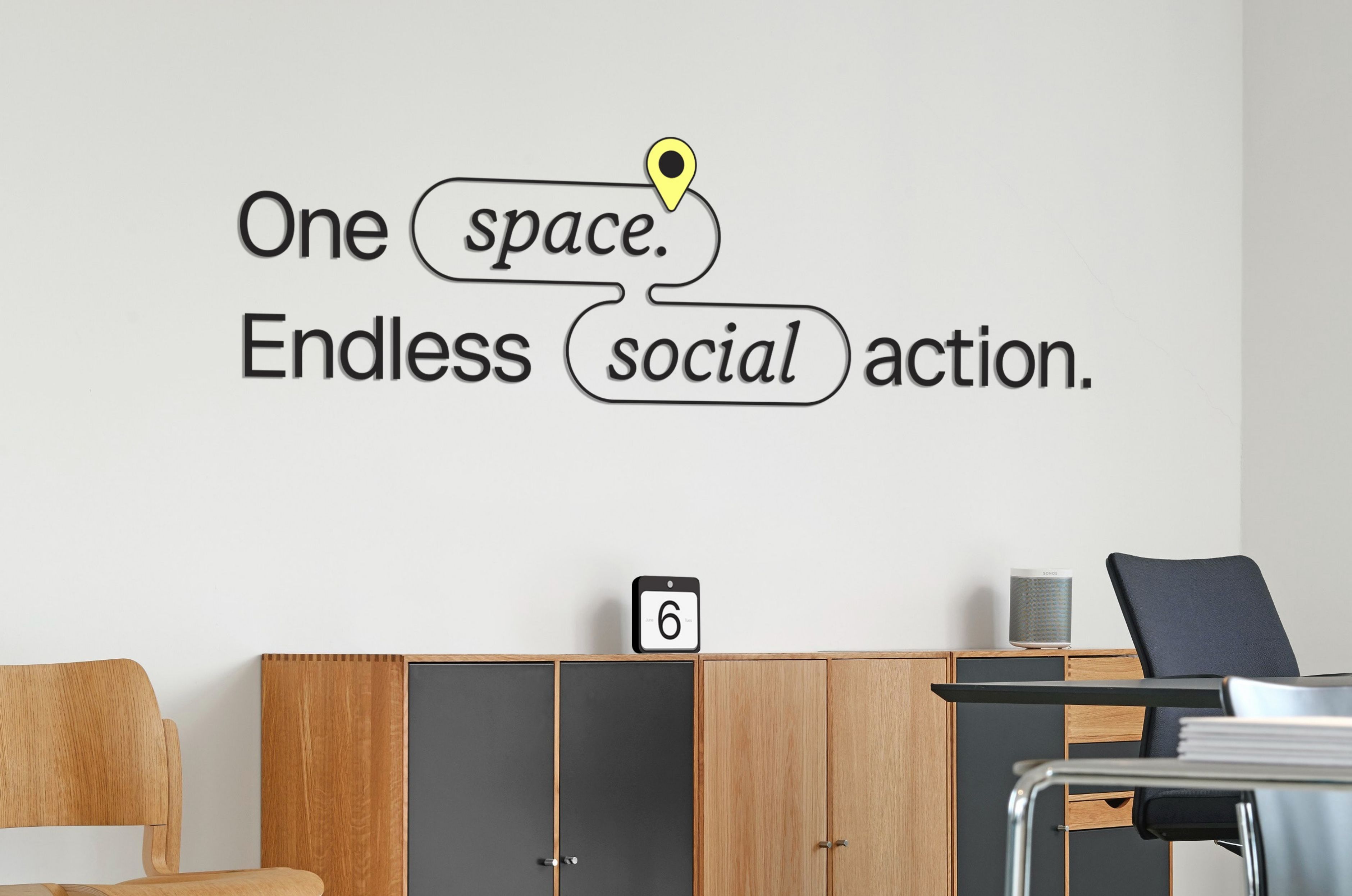 Office signage reading "One space. Endless social action."