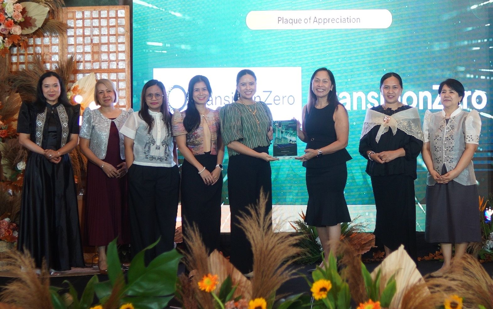 Isabella Suarez, Head of Engagement at TransitionZero receives the award from the Secretary of the Department of Energy (DOE) Sharon Garin