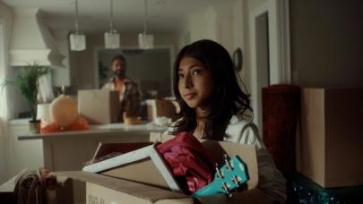 Young girl holding a box of her things