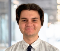 Headshot of a young man in a shirt and tie.