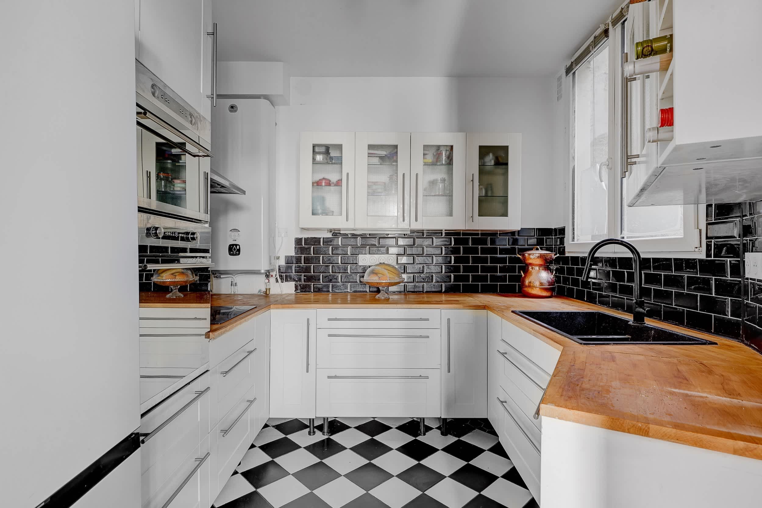 Top-floor Haussmann apartment on rue Meslay near République Paris 3rd, bright dual-aspect living room with designer sofa bed and refined decor
