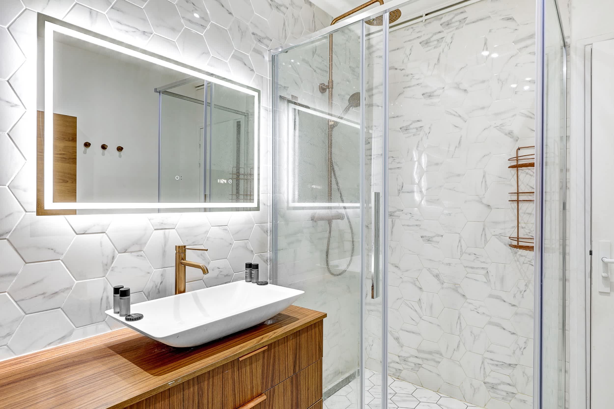 Top-floor Haussmann apartment on rue Meslay near République Paris 3rd, bright dual-aspect living room with designer sofa bed and refined decor