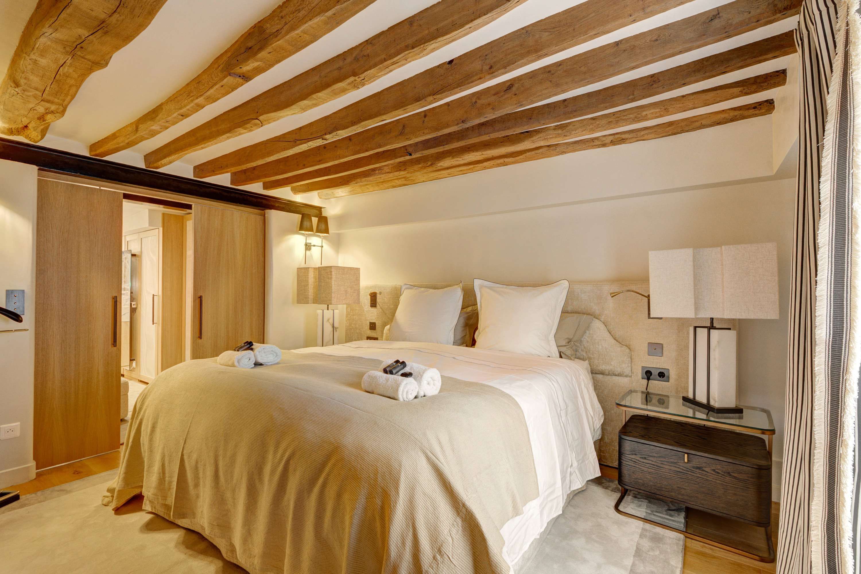 Bedroom 1: features a 160 × 200 cm double bed, storage space, and complimentary welcome amenities.