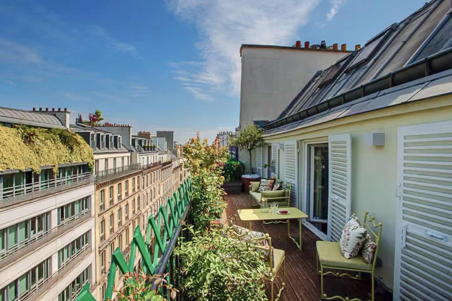 A sun-drenched, flower-filled terrace, perfect for enjoying breakfast outdoors or peaceful evenings in the heart of Paris.