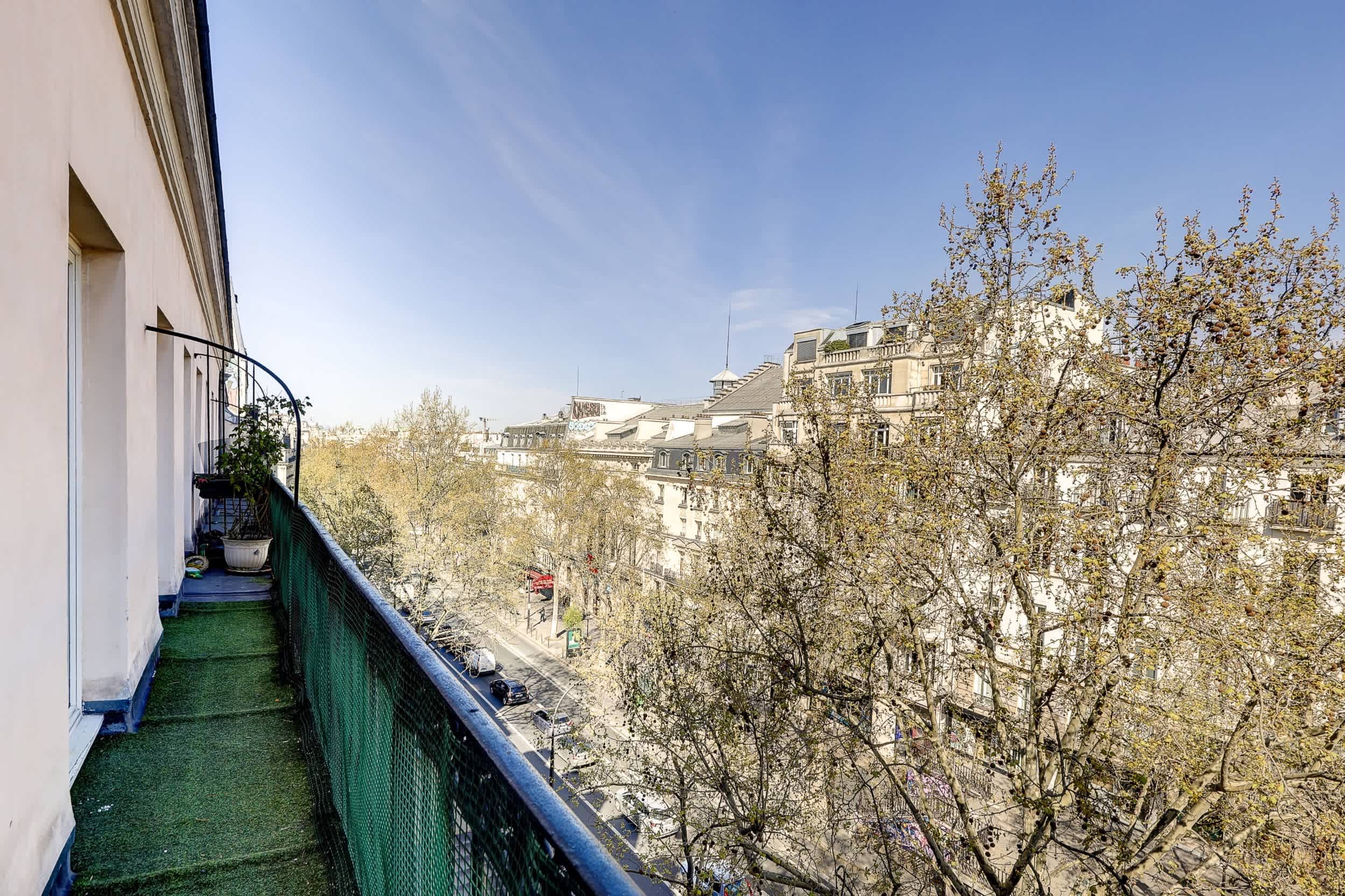 Top-floor Haussmann apartment on rue Meslay near République Paris 3rd, bright dual-aspect living room with designer sofa bed and refined decor