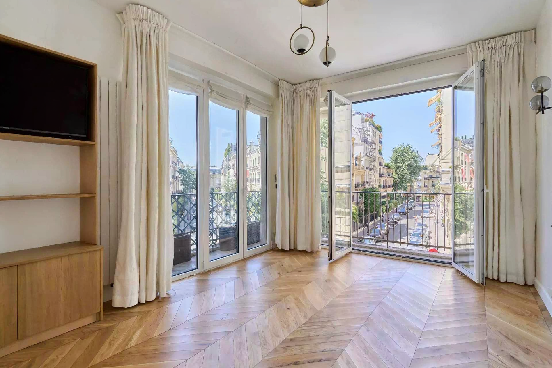 Bright fully furnished Paris apartment with elegant interiors, spacious living areas, balcony access, and comfortable amenities.