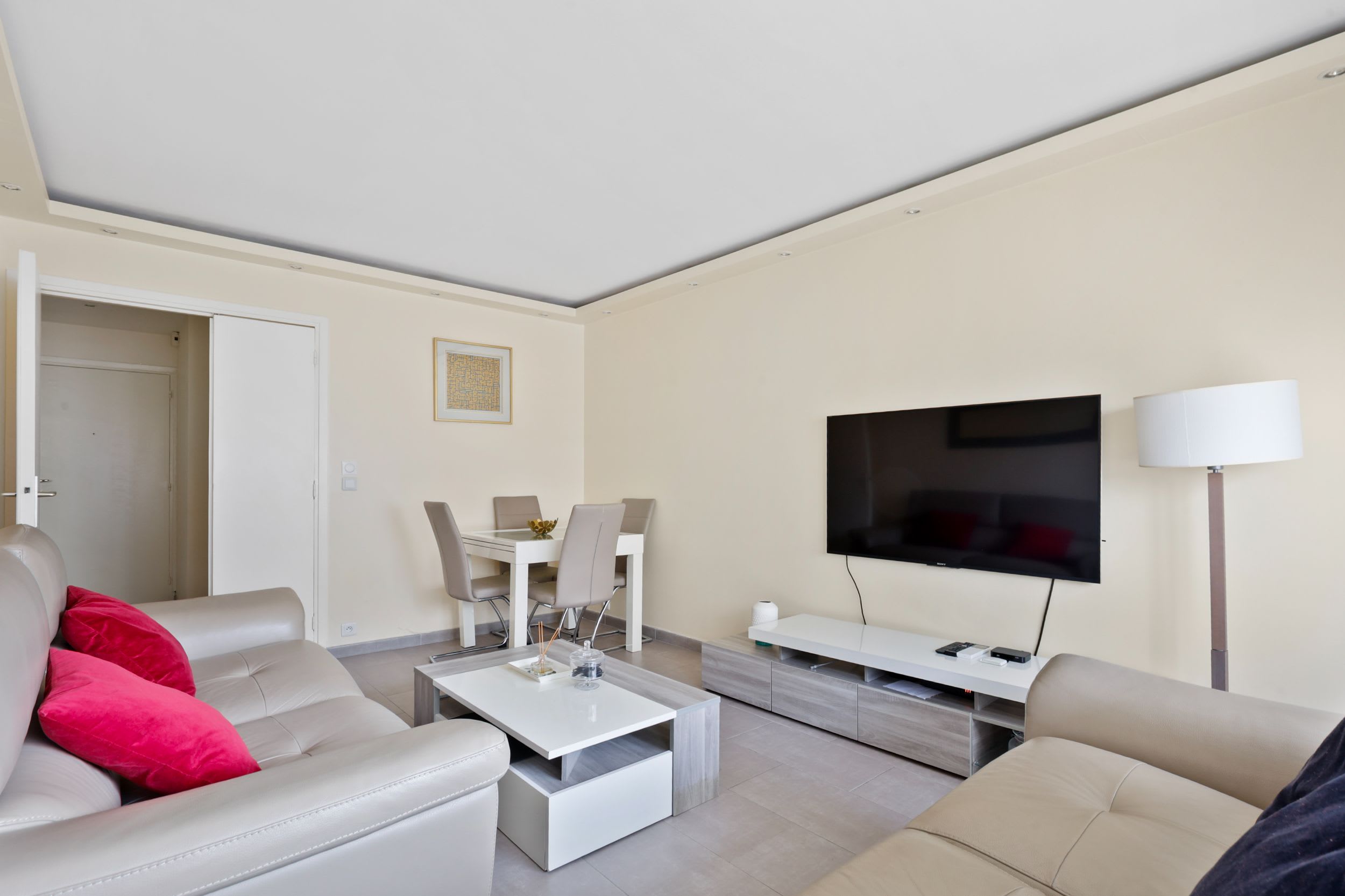 Cozy living space with sofas, Smart TV, and dining areas