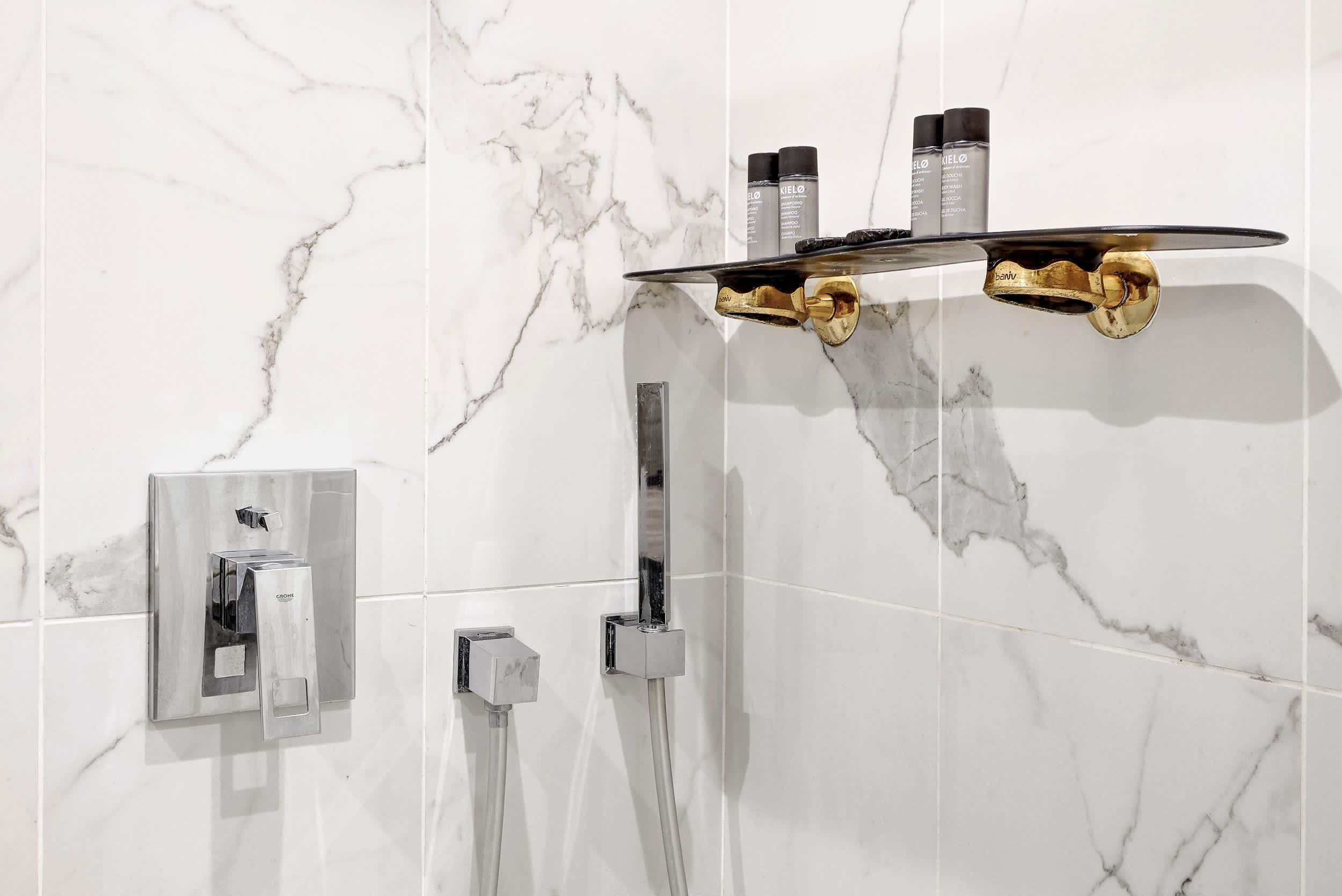Bathroom: shower, double sinks, mirror, and toilet.