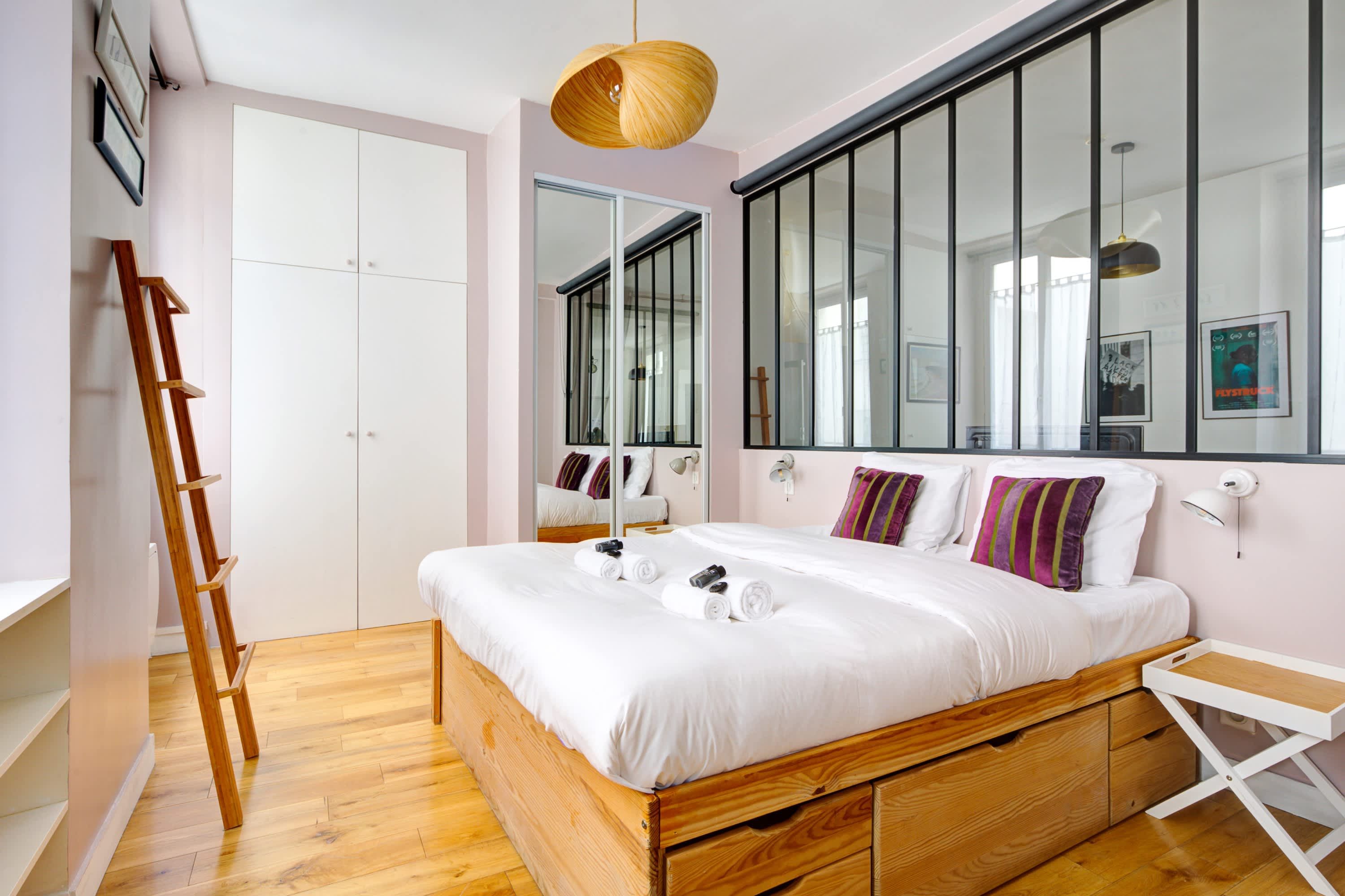 Bedroom with double bed, mirror, and storage space