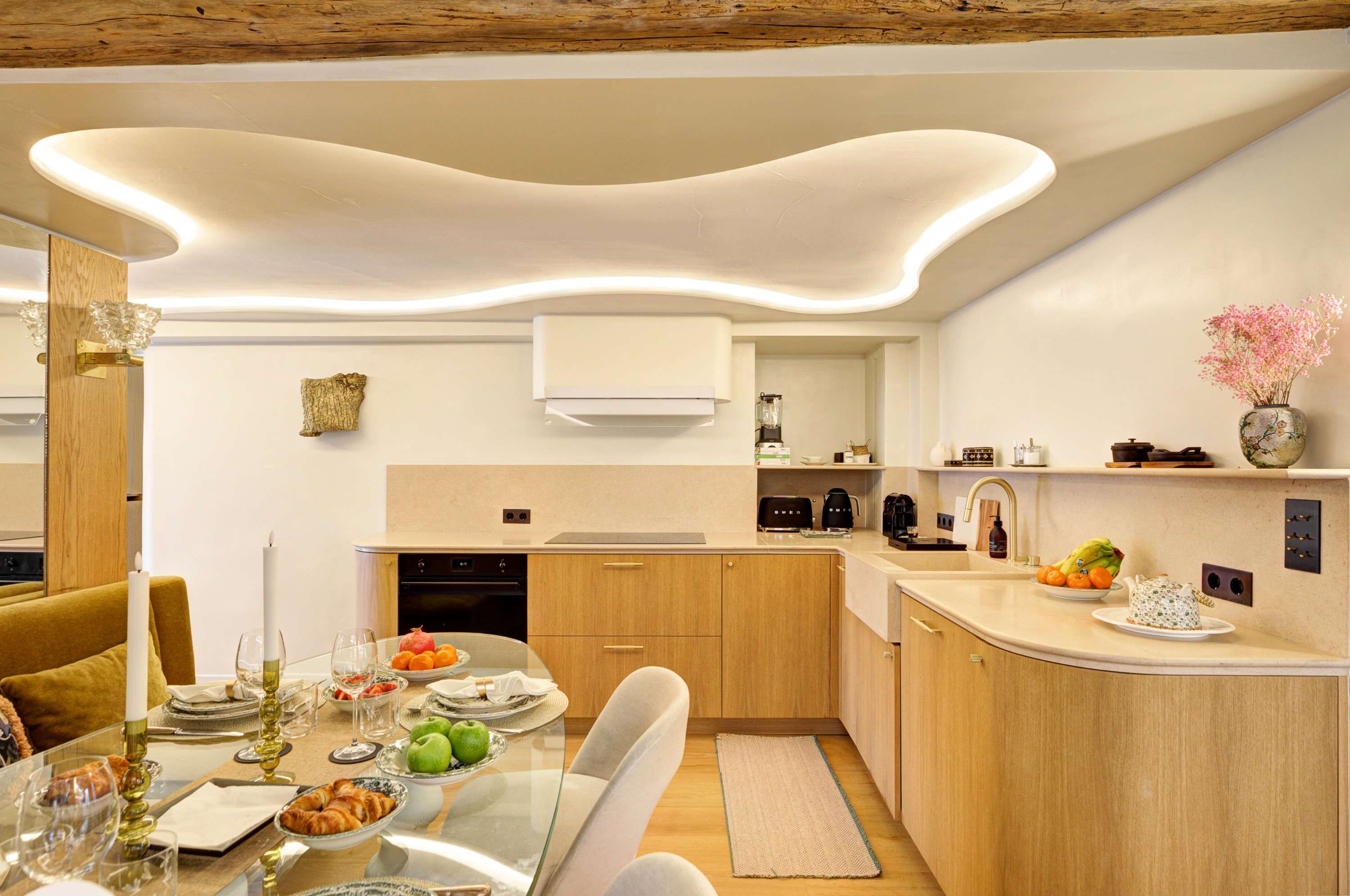 Fully equipped kitchen: oven, microwave, cooktop, coffee machine, kettle, toaster, storage cabinets, and a dining area.