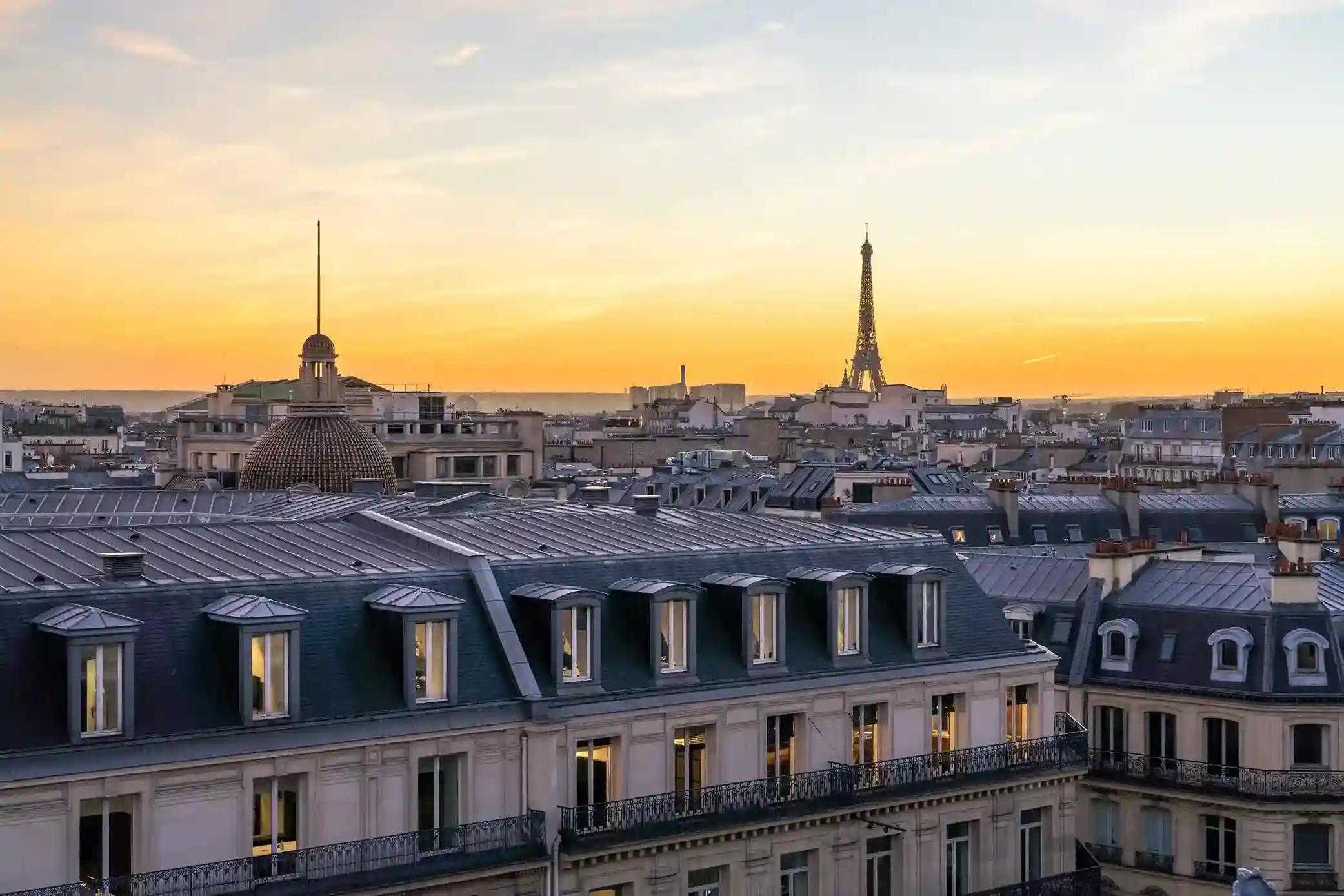 Panoramic view of Paris rooftops with the Eiffel Tower