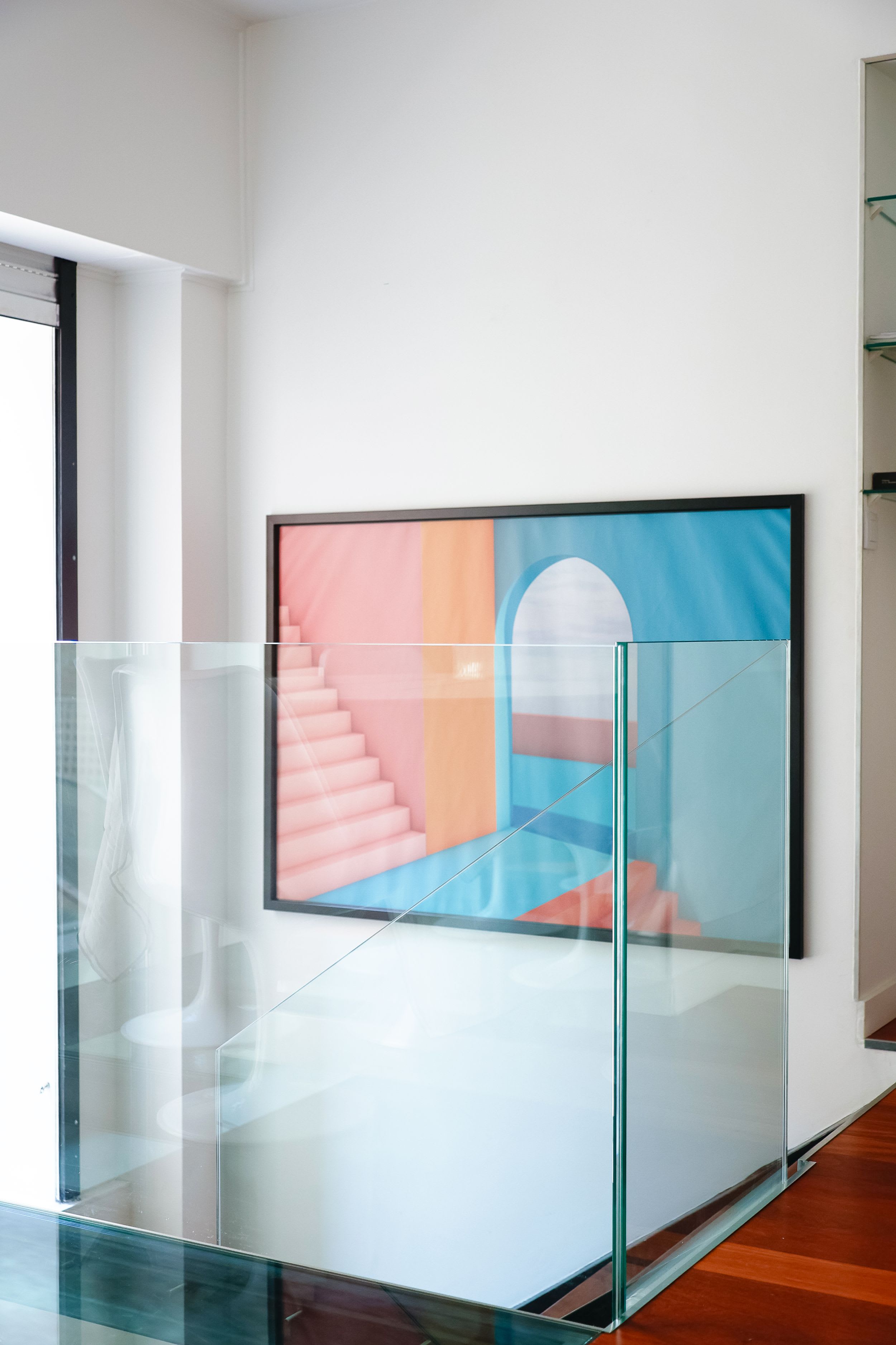 Bright architect-designed Paris apartment with a glass roof, modern open living space, sofa, and open kitchen.